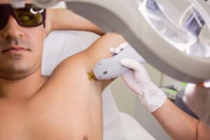 doctor-performing-laser-hair-removal-male-patient-skin_orig